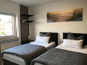 En eller flere senge i et værelse på Villa Cologne - Apartments & Monteursquartiere in Meckenheim bei Köln