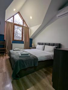 a bedroom with a large bed and a window at Favourite in Sighnaghi