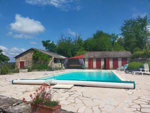 a swimming pool with a large inflatable at L'écurie du Mas in Lamothe-Cassel