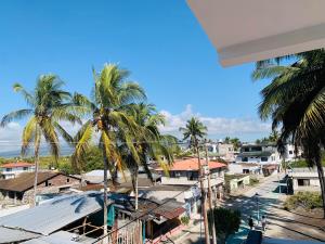 a view from the balcony of a resort with palm trees at Piqueros patas azules in Puerto Villamil