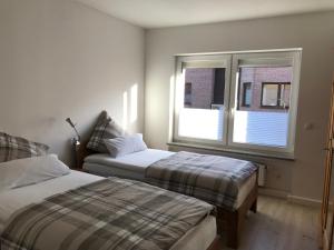 En eller flere senge i et værelse på Villa Cologne - Apartments & Monteursquartiere in Meckenheim bei Köln