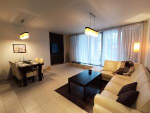 a living room with a couch and a table at Apartament WENGE w centrum Ustronia in Ustroń +1 photo