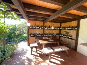 a patio with a table and a bunch of wine bottles at "Mon Rêve" Nature, Tranquility & Lake Thun in Sigriswil
