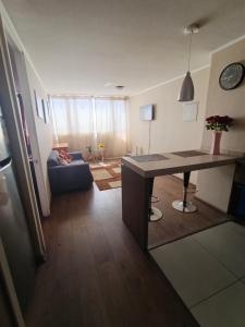 een keuken en woonkamer met een tafel en een bank bij Edificio Concepto in Calama