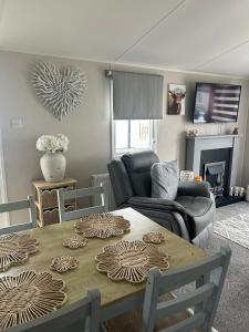 a living room with a table and a couch at Ocean view in Heysham