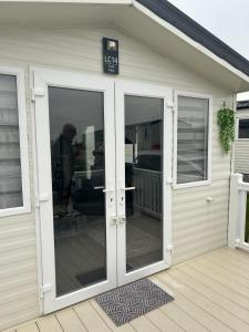 a garage with glass doors and a sign on it at Ocean view in Heysham