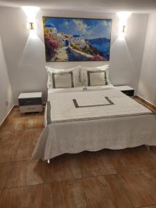 een slaapkamer met een groot bed met een schilderij aan de muur bij Résidence Les Camélias in Tabarka +39 foto's