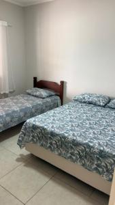 En eller flere senge i et værelse på Casa em Serra Negra