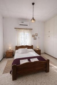 a bedroom with a large bed and two night stands at Forest Park Villa in Lemithou