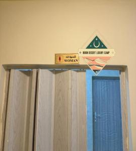 a sign above a door with a sign above it at Moon Desert Luxury Camp in Wadi Rum