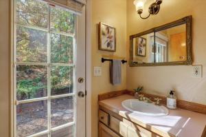 a bathroom with a sink and a mirror and a window at Gold rush nook in Grass Valley +10 photos