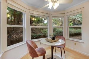 a dining room with windows and a table and chairs at Gold rush nook in Grass Valley