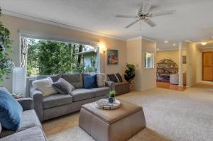 a living room with a couch and a ceiling fan at Gold rush nook in Grass Valley