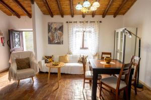a living room with a couch and a table at Cantinho Alentejano-Rua das Hortas, Corte Pao e Agua in Mértola