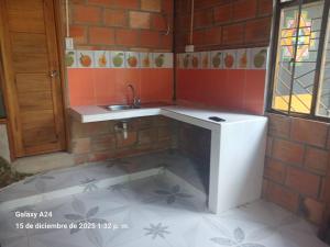 a small bathroom with a sink and a window at Chema in Mocoa