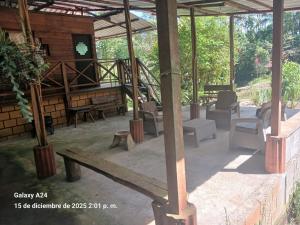 a patio with chairs and a table and a building at Chema in Mocoa