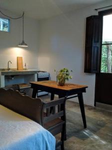 a kitchen with a table with a plant on it at Aloja Merlo in Merlo +10 photos