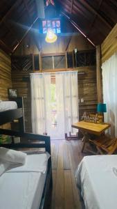 En eller flere senge i et værelse på Arrecife Eco Cabañas Palomino