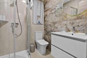 a bathroom with a shower and a toilet and a sink at Contemporary Retreat in St. Paul's Bay +4 photos