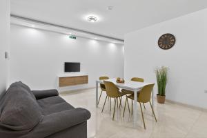 a living room with a couch and a table at Contemporary Retreat in St. Paul's Bay
