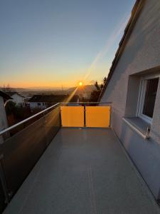 a balcony with a view of the sunset at Forest Home E&L in Waldshut-Tiengen