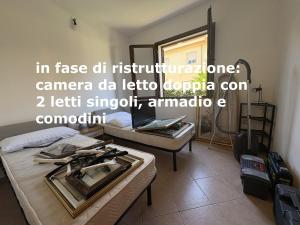 En eller flere senge i et værelse på MICHI Holiday Home Tortolì