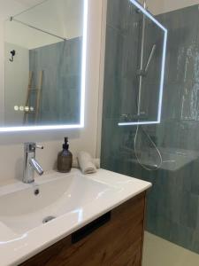 a bathroom with a sink and a shower with a mirror at Blue House in Santa Cruz with Sea View in Santa Cruz +28 photos