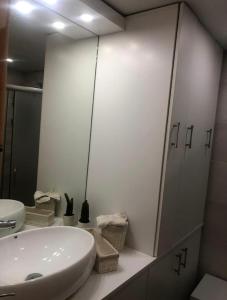 a white bathroom with a sink and a mirror at Chalet des Caraïbes in Batroûn +18 photos