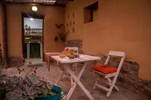 a white table and a chair in a room at La Cabañita de Tilcara in Tilcara
