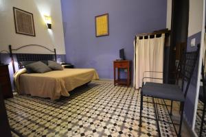 Ein Bett oder Betten in einem Zimmer der Unterkunft Hotel Casa de los Azulejos