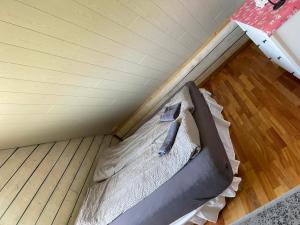 a bed in a room with a wooden floor at Vestra-Fíflholt 2 herbergja íbúð, fyrir allt að 8 gesti in Hvolsvöllur