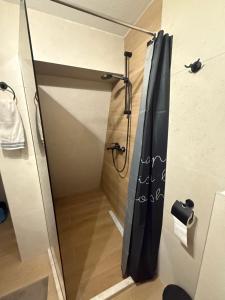 a shower with a black shower curtain in a bathroom at Lunara Vlasic in Vlasic +20 photos