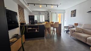 a kitchen and living room with a table and a couch at Casa de ogracia in Rojales