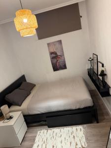 a small bedroom with a bed and a chandelier at Casa de ogracia in Rojales +17 photos
