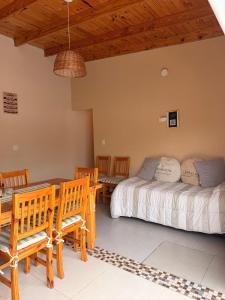 a bedroom with a bed and a table and chairs at QUINTA BELEN Cañuelas in La Porteña +28 photos