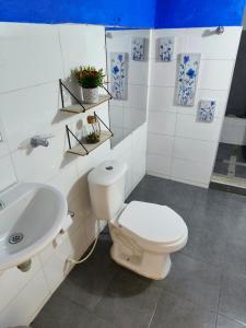 a bathroom with a toilet and a sink at Casa Terraza in El Zaino +14 photos
