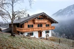 a wooden house on top of a hill at Berg'k'hof Kaisertal - Alpine Hideaway in Ebbs