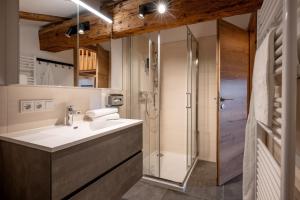 a bathroom with a sink and a shower at Berg'k'hof Kaisertal - Alpine Hideaway in Ebbs +97 photos