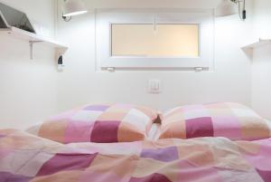 a bed with two pillows in a room with a window at Notre-Dame luxury Suite in Saint-germain des prés Latin quarter in Paris