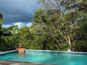 a man in a swimming pool in a forest at Maze Lodge in Puerto Jiménez +63 photos
