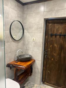 a bathroom with a stone sink and a mirror at Rilski Chardak in Sapareva Banya +23 photos
