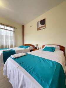 Giường trong phòng chung tại Hotel Casa Cascada