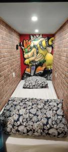 een slaapkamer met een muur waarop een muurschildering van de Simpsons te zien is bij Maison game in Villeneuve-sous-Dammartin