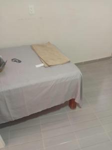 a white bed with a blanket on top of it at Casa alexander in Acapulco