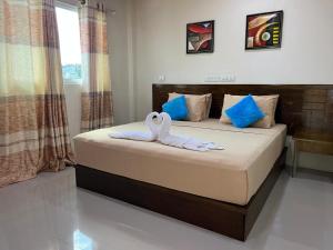 two swans towels sitting on a bed in a bedroom at Oceanvine in Mahibadhoo