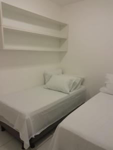 En eller flere senge i et værelse på Aluguel de Temporada Bosque de Guarajuba