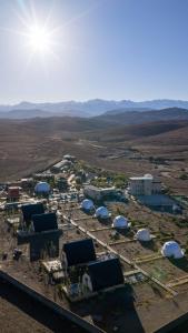 an aerial view of a farm with domes and buildings at The Ranch Resort in Marrakech