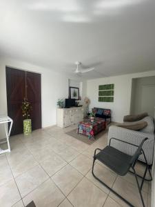a living room with a couch and a chair at Rayon des îles bien désirée in Saint-François
