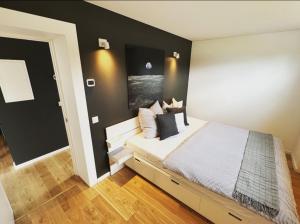 a bedroom with a bed with a black wall at Airpark-Lodge in Lärz
