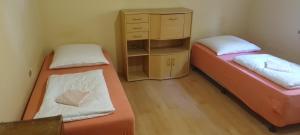 twee bedden in een kleine kamer met een ladekast bij Apartament ist im swineminde ! & erdgeschos in Ahlbeck